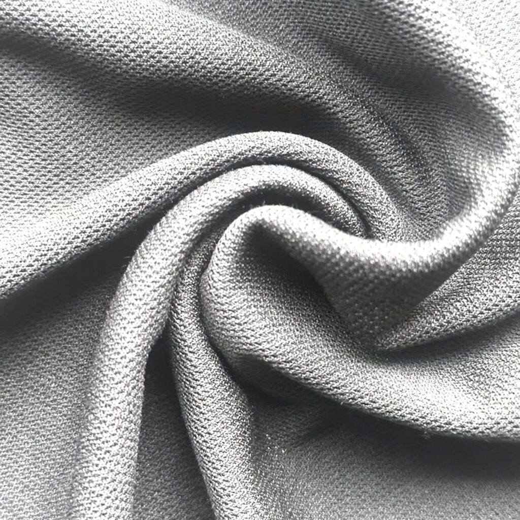 Cotton mesh fabric swatch showing the open two-layer knit structure