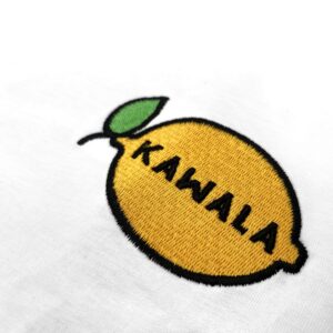 Embroidered lemon logo badge in yellow, green and black on a white cotton t-shirt