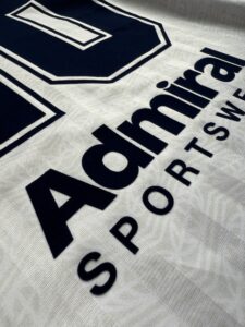 Navy flock print lettering with a soft velvet texture